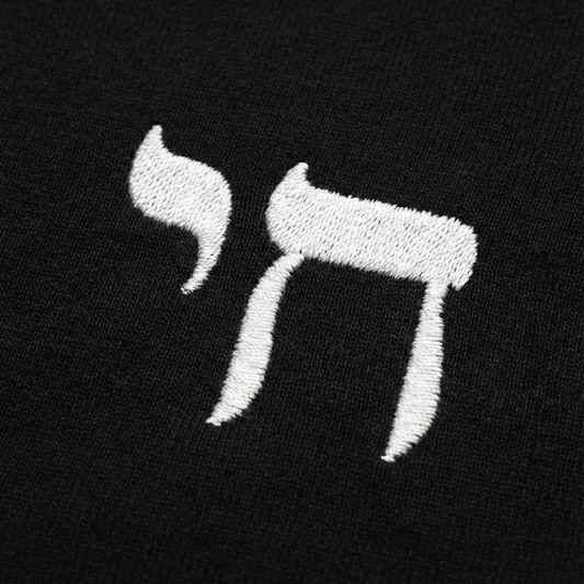 Embroidered letter 'Chai' in white on a black background