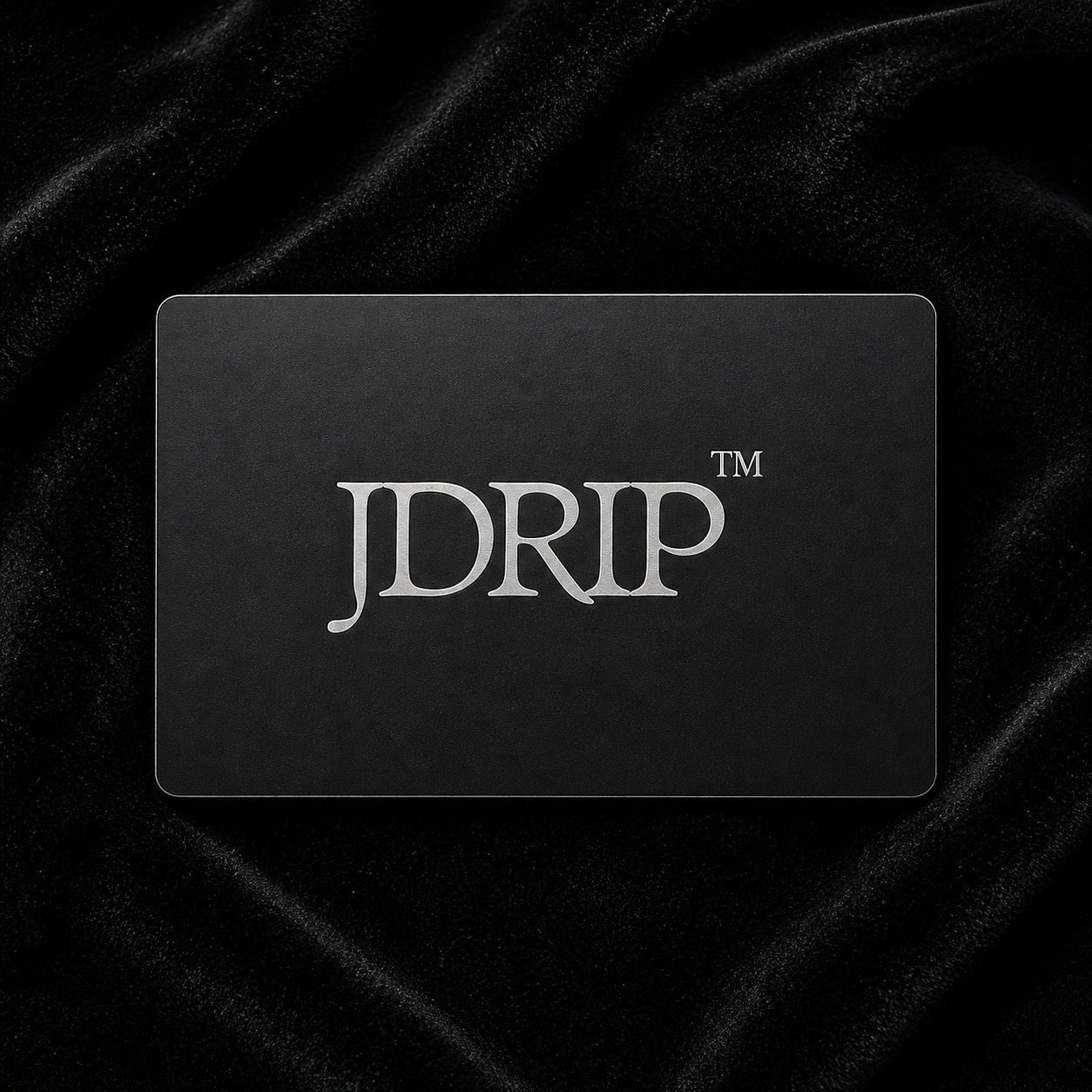 Black gift card with "JDRIP" logo on black velvet