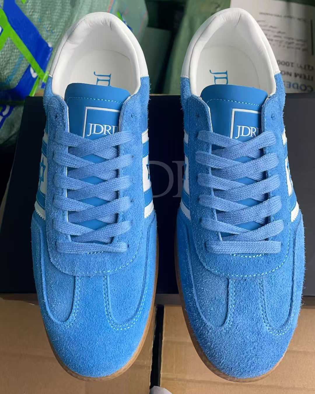 Israel shoes. Pair of blue Israel sneakers with an Israeli flag design on a shoe box, from the top